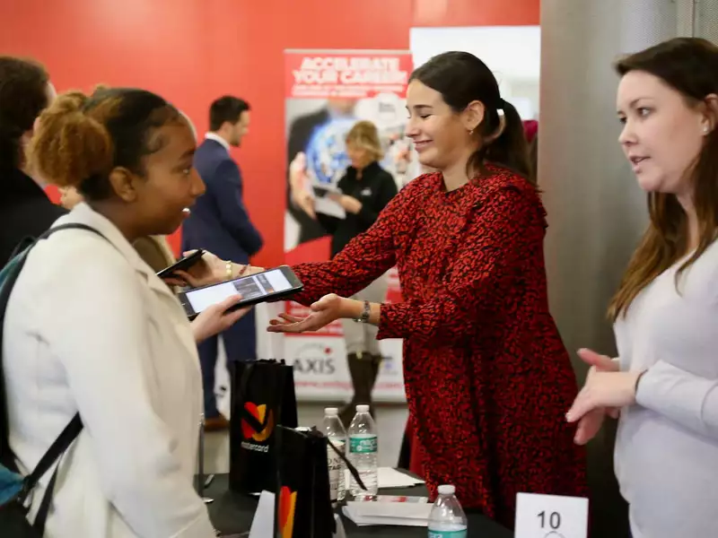 Young Black woman speaks with a white woman recruiter